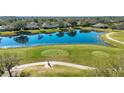 Scenic aerial view of the golf course; a tranquil pond and lush green grasses define an idyllic outdoor space at 2313 Brookfield Greens Cir # 35, Sun City Center, FL 33573