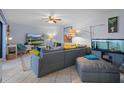 Bright living room with comfortable gray sectional, tile floors, and modern decor at 2612 6Th Ct, Palm Harbor, FL 34684