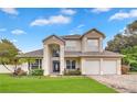 Beautiful two-story home with a well-kept lawn, brick driveway, and attached three-car garage at 3018 N 164Th Pl, Clearwater, FL 33760