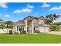Stunning two-story home featuring a well-manicured lawn and a three-car garage, perfect for a growing Gathering at 3018 N 164Th Pl, Clearwater, FL 33760