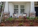 Inviting front porch with stone pillars and comfortable seating, perfect for relaxing at 3203 Park Green Dr, Tampa, FL 33611