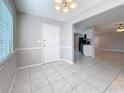 The bright dining room features tile flooring, neutral paint, and an entry view to the kitchen at 37143 Janet Cir, Dade City, FL 33525