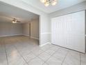 Spacious dining room featuring tile flooring, neutral paint, closet, and modern light fixture at 37143 Janet Cir, Dade City, FL 33525