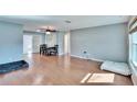Spacious living room featuring hardwood floors, neutral paint, and a modern ceiling fan at 415 Maplewood Cir, Oldsmar, FL 34677