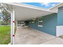 Attached covered parking area showcasing the home's exterior paint colors at 4638 Heavens Way, New Port Richey, FL 34652