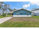 Well-maintained blue home with white trim and a spacious front yard on a sunny day at 4638 Heavens Way, New Port Richey, FL 34652