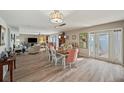 Bright dining room with wood floors, modern lighting, and views of the water at 4842 Coquina Key Se Dr # B, St Petersburg, FL 33705