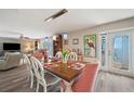Dining room with wood floors, modern lighting, and seating for six at 4842 Coquina Key Se Dr # B, St Petersburg, FL 33705
