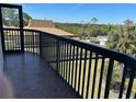 Inviting balcony with a black metal railing, offering serene views of the landscape and pool area at 5400 Park N St # 214, St Petersburg, FL 33709