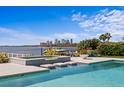 Luxury pool with bay view, mosaic tile spa, and stepping stones offers a tranquil outdoor experience at 611 Brightwaters Ne Blvd, St Petersburg, FL 33704