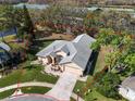 Aerial view of a beautiful home with a large yard and mature trees at 8233 Danubian Pl, Trinity, FL 34655