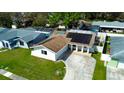 Aerial view of a single-story home with a pool, solar panels, manicured lawn, and a driveway at 9137 85Th Ave, Seminole, FL 33777