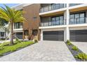 The front exterior of the modern townhome features a private garage and a manicured lawn at 101 W Warren Ave # 1, Tampa, FL 33602
