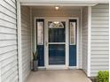 The home has a beautiful blue front door, side windows, and modern light fixture at 11722 Currie Ln # G1, Largo, FL 33774