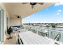 Relaxing balcony with outdoor furniture and serene water views at 125 Island Way # 402, Clearwater Beach, FL 33767