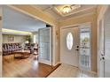 Bright foyer with tile floors and living room view through glass paneled doors at 1518 New Bedford Dr, Sun City Center, FL 33573