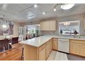 Open kitchen with light wood cabinetry and dining area at 1518 New Bedford Dr, Sun City Center, FL 33573
