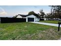 Attractive single-story home boasting a lush green lawn and a practical two-car garage at 18614 San Rio Cir, Lutz, FL 33549