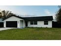 Inviting single-story home with a well-manicured lawn and a convenient two-car garage at 18614 San Rio Cir, Lutz, FL 33549