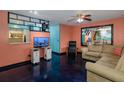 Cozy living room with a large sofa, mounted television, and unique wall mirror and decor at 2100 World Parkway Blvd # 30, Clearwater, FL 33763