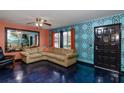 Bright living room featuring a comfortable sofa and a large mirror, with views to the outside at 2100 World Parkway Blvd # 30, Clearwater, FL 33763