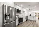 Modern kitchen featuring stainless steel appliances, white cabinets, and sleek countertops at 2101 Cordova Grn, Seminole, FL 33777