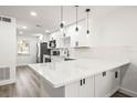 Updated kitchen with quartz countertops, stainless appliances, and modern pendant lighting at 2101 Cordova Grn, Seminole, FL 33777