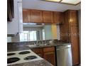 Kitchen featuring granite countertops, ample cabinets, and stainless steel appliances at 233 Woodlake Wynde, Oldsmar, FL 34677
