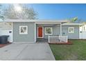 Charming home featuring a front porch and a well-maintained lawn at 304 David Ave, Clearwater, FL 33759