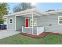 Charming home with a cozy front porch and red door at 304 David Ave, Clearwater, FL 33759