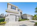 Stately home features a stone facade, three-car garage, brick driveway, and well-manicured landscaping at 3280 Juniper Springs St, Wesley Chapel, FL 33543
