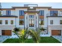 Contemporary two-story home with sleek lines, manicured lawn, and a welcoming entrance at 4005 Casey Key Rd, Nokomis, FL 34275