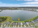 Stunning aerial view showcasing the waterfront property's location on a serene lake, surrounded by a peaceful neighborhood at 42211 Edgewater Dr, Punta Gorda, FL 33982