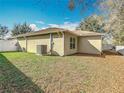 View of the home's backyard showing the AC unit and partial fence at 4441 Fieldview Cir, Wesley Chapel, FL 33545