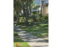 Lush front yard with mature trees and meticulously manicured shrubs along a sidewalk in a quiet neighborhood at 5231 Bayshore Blvd # 10, Tampa, FL 33611