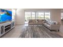 Bright living room features sliding glass doors and a comfortable sectional sofa at 5934 Maidenstone Way, Palmetto, FL 34221