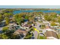 Community aerial view with lake, solar panels, fenced yard, and convenient access to the main highway at 7213 Trinity Pl, Tampa, FL 33610
