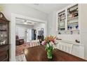 Bright dining room featuring built-in shelving with an open view to the living area at 8306 N 10Th St, Tampa, FL 33604