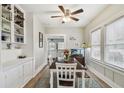 Well-lit dining room with wood floors, large windows, and built-in cabinets at 8306 N 10Th St, Tampa, FL 33604
