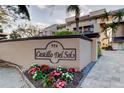 Exterior community sign for Castillo Del Sol with beautiful landscaping at 936 Pinellas Bayway S # T-7, Tierra Verde, FL 33715