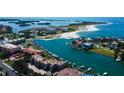 Stunning aerial view of waterfront condos, beach, and boat docks on a sunny day at 936 Pinellas Bayway S # T-7, Tierra Verde, FL 33715
