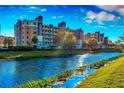 Exterior view of the condominium complex with manicured lawns and a serene waterfront setting at 960 Starkey Rd # 3406, Largo, FL 33771