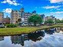 Stunning exterior of the building reflecting off a lake, displaying a well-maintained facade and landscaping at 960 Starkey Rd # 3406, Largo, FL 33771