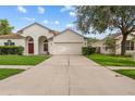 Charming single-Gathering home showcasing a well-maintained lawn and two-car garage at 11611 Jordans Landing Ct, Riverview, FL 33569