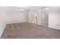 Spacious living room with neutral walls, soft carpeting and arched entryways at 11611 Jordans Landing Ct, Riverview, FL 33569