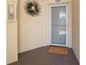 Welcoming condo entrance with wreath and 'Welcome' mat offering a charming first impression at 1200 Country Club Dr # 4301, Largo, FL 33771