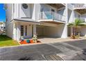 Coastal home with outdoor parking, an inviting entrance, and space for a small palm tree at 125 Shoals Cir, North Redington Beach, FL 33708