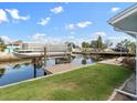 Canal-front backyard with a private dock, lush lawn and convenient boat access at 13437 Lisa Dr, Hudson, FL 34667