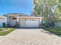 Beautiful home with brick driveway and well-maintained landscaping, creating an inviting curb appeal at 13542 Norman Cir, Hudson, FL 34669