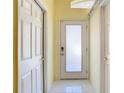 Bright hallway with tile flooring and doors, creating a clean and spacious feel at 13542 Norman Cir, Hudson, FL 34669